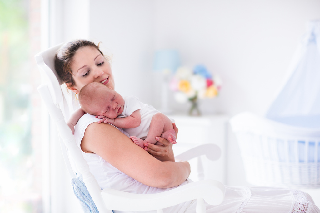 Young mother holding her newborn child.