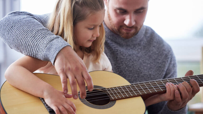 little daughter playing guitar