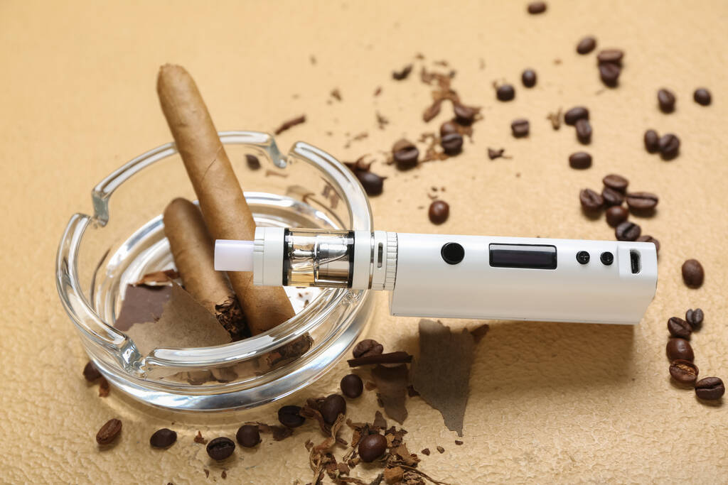 Modern vape mod, cigars and coffee beans